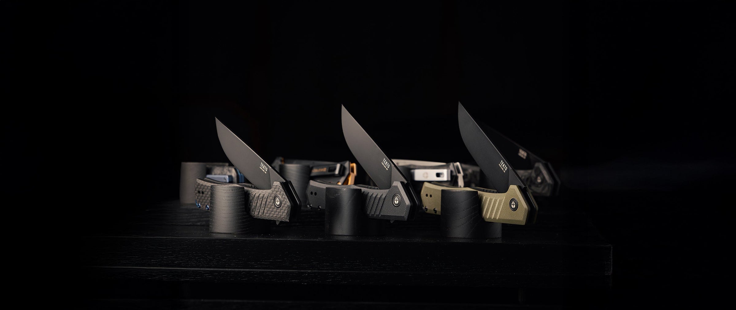 TEKTO knives laid out with everyday carry gear