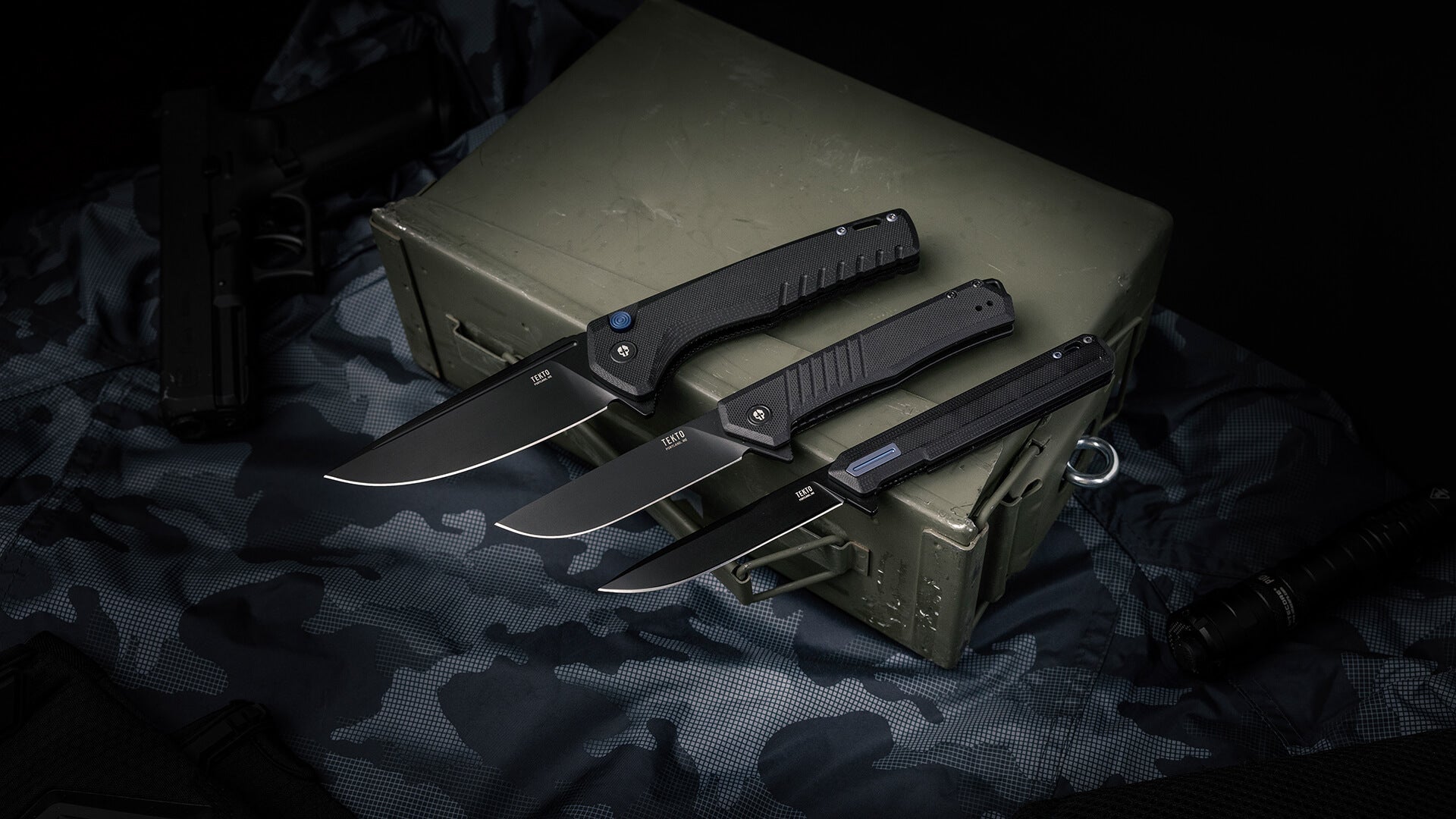 Black G10-handled TEKTO folding knives with titanium-coated D2 blades
